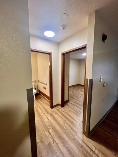 Hallway to bedroom and bathroom in a living space offered through affordable housing services